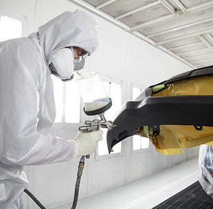 Collision Center Technician Painting a Vehicle | Hubler Toyota in Indianapolis IN